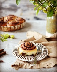 Cinnamon buns in a plate on a gray background, still life