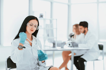 close up.woman scientist takes a sample of the liquid .