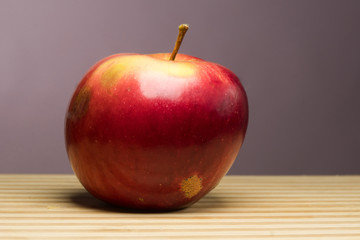 juicy apple isoloated on gray background on the desk.