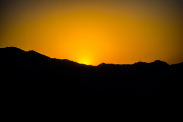 Sunrise behind the mountains of Rishikesh, Located in the foothills of the Himalayas in northern India,
