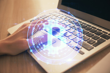 Double exposure of woman hands typing on computer and crypto market theme hologram drawing....