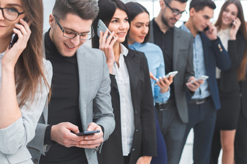 group of diverse young people use their smartphones