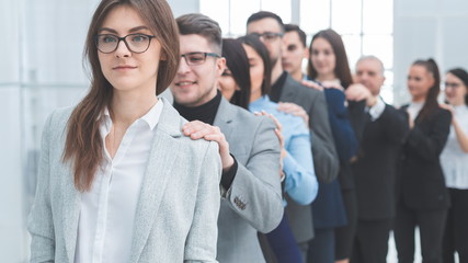 group of young business people standing behind each other