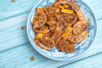 Thai food, Fried Crispy shrimp with herbs and spices on old ceramic dish with Blue Wooden Background , Flat Lay Out, Top View Angle