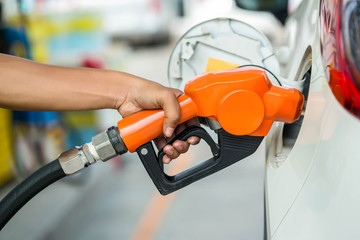 Man Refill and filling Oil Gas Fuel at station.Gas station - refueling.To fill the machine with...