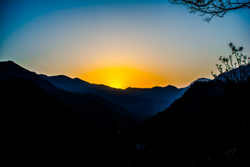 Sunrise behind the mountains of Rishikesh, Located in the foothills of the Himalayas in northern India,
