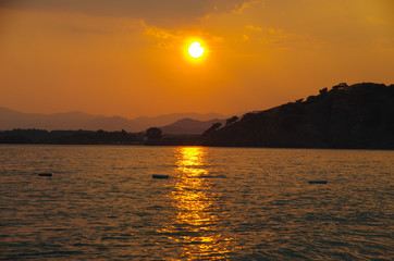 Naklejka premium Sunset on the Calis Beach on the Aegean Sea