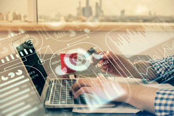 Double exposure of man hands holding a credit card and tech theme drawing. Technology in E-commerce concept.