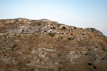 View of Gravina river canyon and park of the Rupestrian Churches of Matera with houses in caves di Murgia Timone near ancient town Matera (Sassi), , Basilicata,  Italy