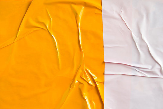 Orange and white crumpled paper placard with rough and wavy surface texture background.