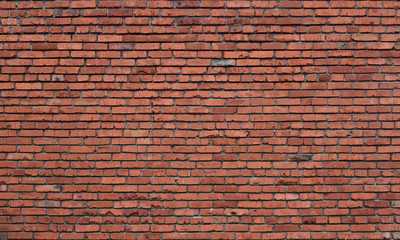 Obraz premium Old brick wall of red blocks with crumbling texture.