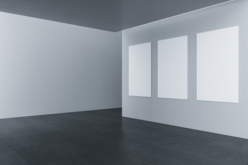 Contemporary gallery interior with three empty banners on wall.