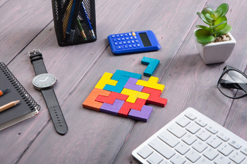 Business creative idea and teamwork concept - jigsaw puzzle, notebook on the wooden desk