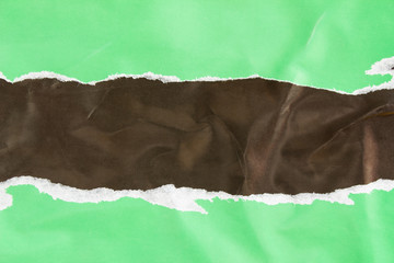 Green and black torn and crumpled glossy paper placard and poster with rough surface texture...