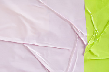 Pink and green crumpled paper placard with rough and wavy surface texture background. Copy space...