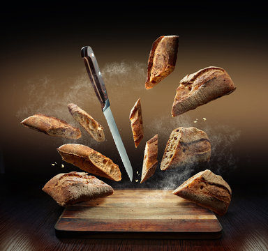 Creative Composition Of Flying Bread, Flour, Crumbs And A Knife