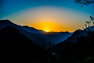 Sunrise behind the mountains of Rishikesh, Located in the foothills of the Himalayas in northern India,

