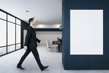 Businessman walking in loft coworking office interior