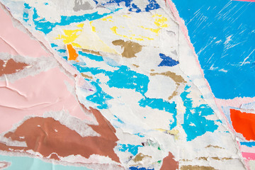 Pink and blue torn crumpled and peeling pieces of old paper layers on billboard. Abstract urban...