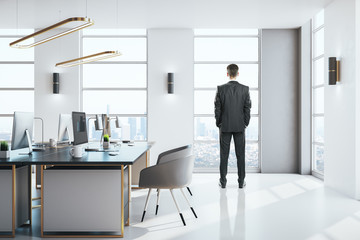 Businessman standing in modern office interior