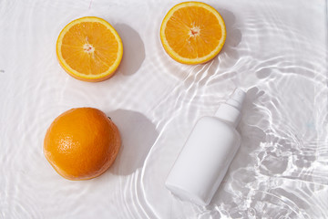 White bottle flacon cosmetics beauty product for skin care face cream and body lotion  shower gel natural organic cosmetology in water drop pure beautiful.