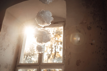 photo of paper flower hanged infront of a window