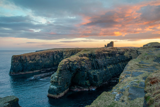 sunset on Old Wick Castle circa 1100 sits on a dramatic promontory 