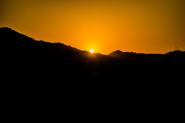 Sunrise behind the mountains of Rishikesh, Located in the foothills of the Himalayas in northern India,
