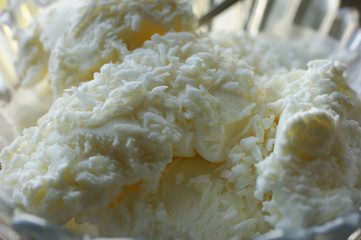 White ice cream with coconut in a glass plate
