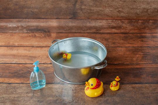 Bath time background for one year baby photo shoot. Backstage. With yellow ducks. 