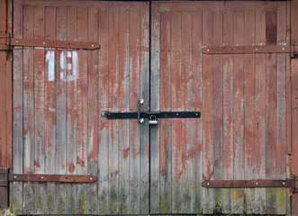 Gray wooden double door, old garage door, taupe boards