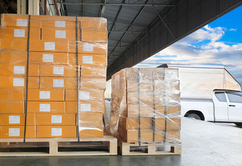 Interior of warehouse dock, stack of package boxes, large pallet shipment goods, truck cargo dock warehouse loading shipment goods , road freight industry delivery, shipping ,logistics and transport