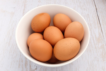 Fresh eggs on wooden background
