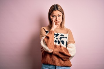 Young beautiful blonde woman wearing fashion animal print sweater over pink background thinking looking tired and bored with depression problems with crossed arms.