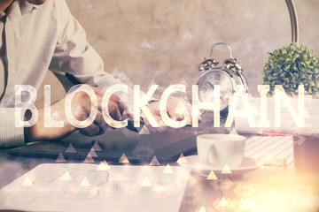 Double exposure of man's hands holding and using a phone and crypto currency blockchain theme drawing.