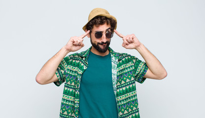 young tourist man looking concentrated and thinking hard on an idea, imagining a solution to a...