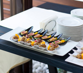 Wedding banquet in the open air. Snacks on the table. Table setting.