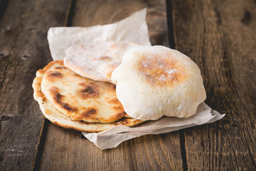 Fresh pita bread on a wooden table