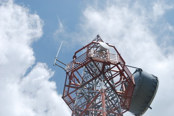 radar tower in the sky with clouds