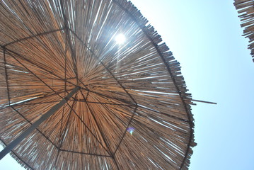 Wooden beach umbrella in sky