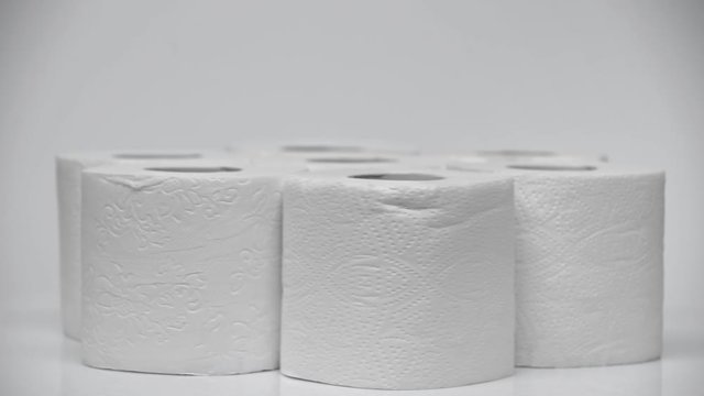 selective focus of soft toilet paper rolling on white