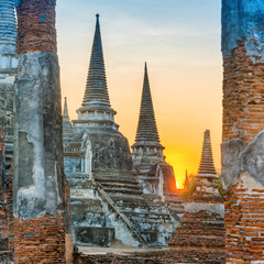 Brick ruins and three white stupas of ancient buddhist temple Wat Phra Si Sanphet. Historical architecture of Ayutthaya, Thailand - obrazy, fototapety, plakaty