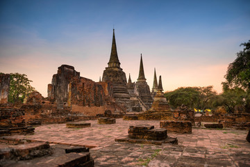 Brick ruins of ancient buddhist temple Wat Phra Si Sanphet at sunset. Architecture of Ayutthaya historical park, Thailand