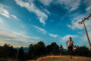 Fototapeta na wymiar Portrait of a silhouette trail runner exercising for fitness