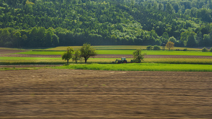 a tractor in the field - green, rural landscape