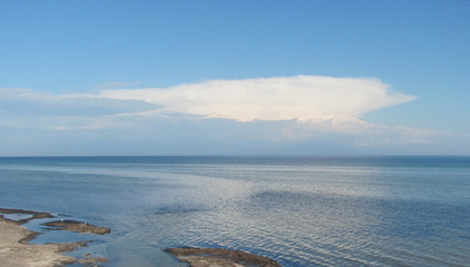 white clouds over the bay a sunny spring day