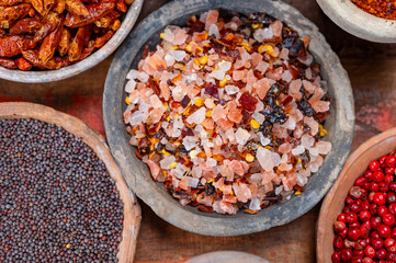 Indian spices collection, sea and rock salt mixed with red hot chili peppers and another spices in clay bowls