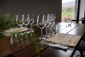 Beautiful table setting in a restaurant with empthy wine glasses. European gourmet restaurant. Cozy interior in the cafe.