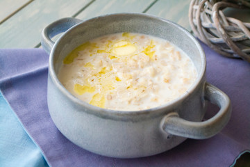 Milk soup with dough on wooden table