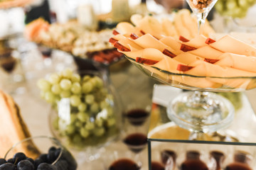 kind of cheese. catering services in restaurant outdoor on wedding ceremony. Food and glass of champagne. restaurant. Set